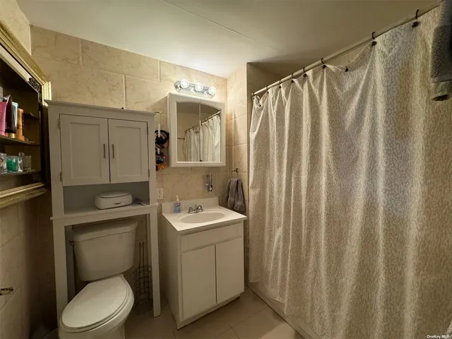 a bathroom with a toilet a sink and a shower