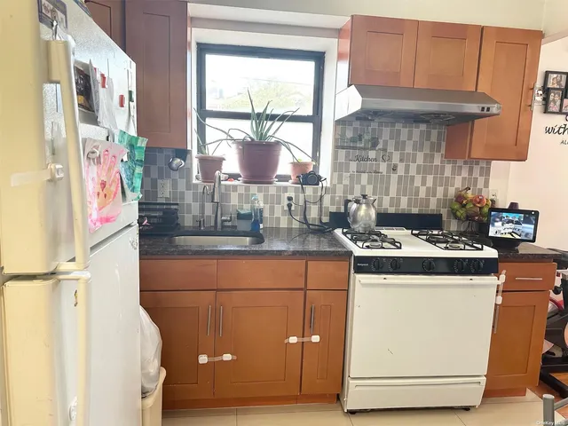 a kitchen with a stove and a refrigerator