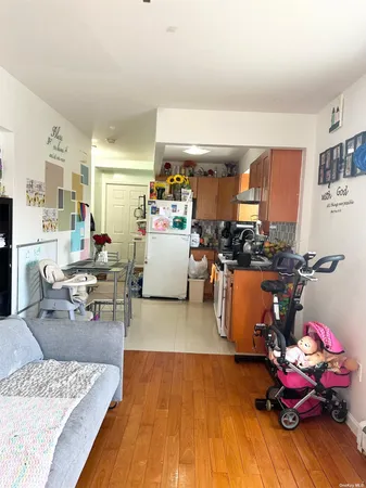 a living room with furniture and kitchen view
