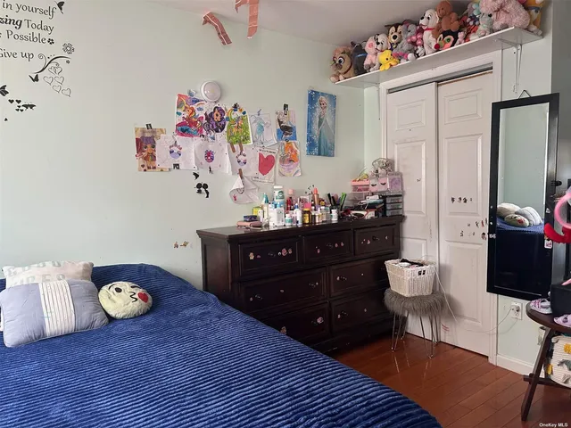 a bedroom with a bed and a dresser in it