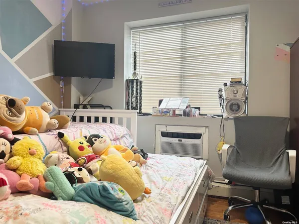 a bedroom with a bed and large windows