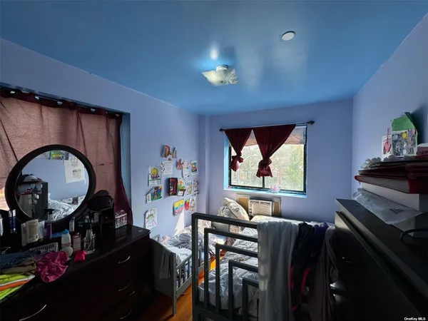 a living room with furniture and a mirror