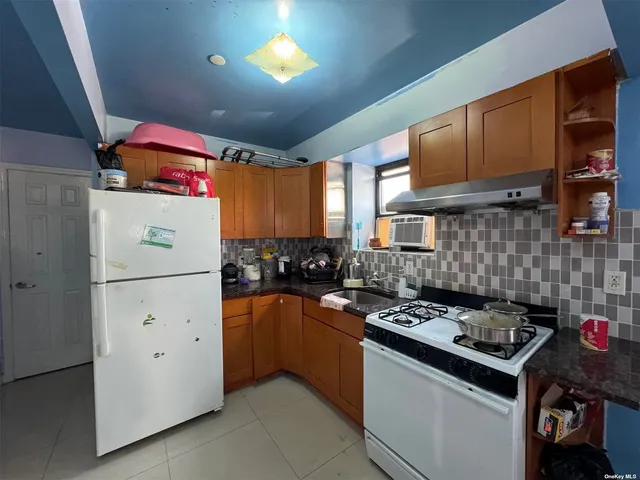 a kitchen with stainless steel appliances granite countertop a refrigerator stove a sink dishwasher and cabinets with wooden floor