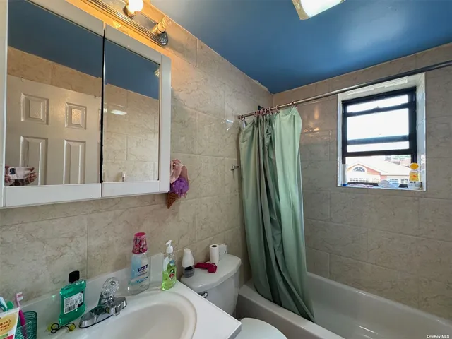 a bathroom with a sink mirror toilet and shower