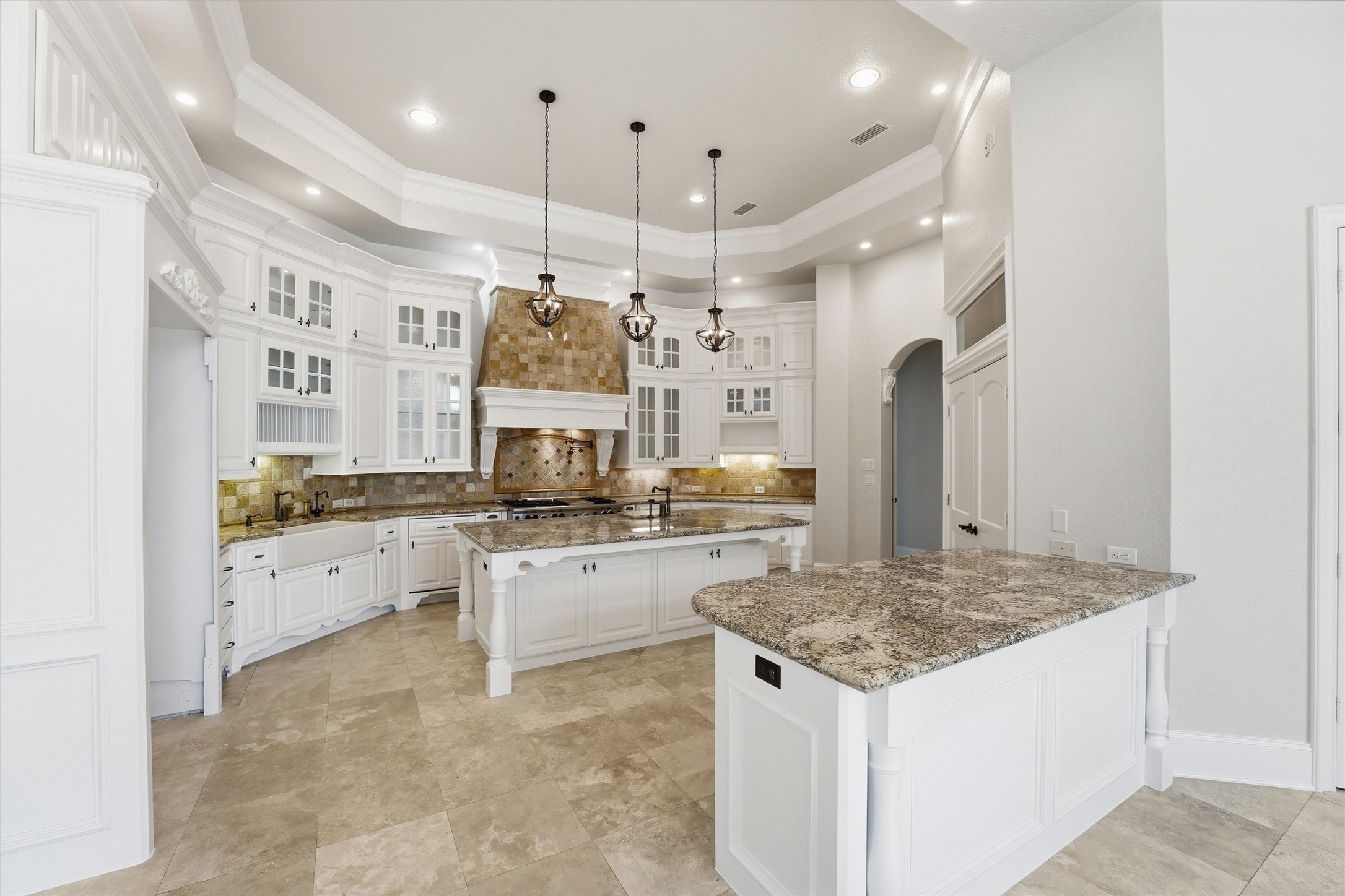 70 Quail Rock Place The Woodlands, TX 77381 - Photo 9 of 46 a kitchen with stainless steel appliances kitchen island granite countertop a stove and refrigerator