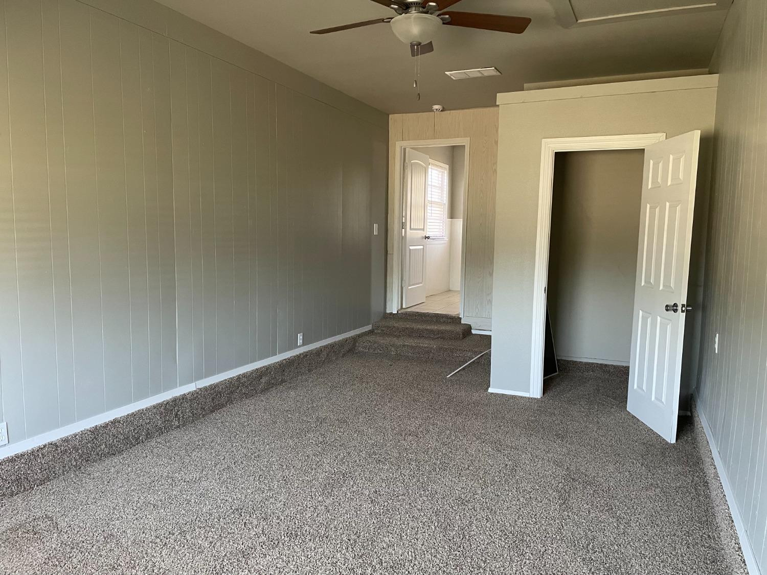 6501 Avenue T Lubbock, TX 79412 - Photo 12 of 20 an empty room with a empty space and a ceiling fan