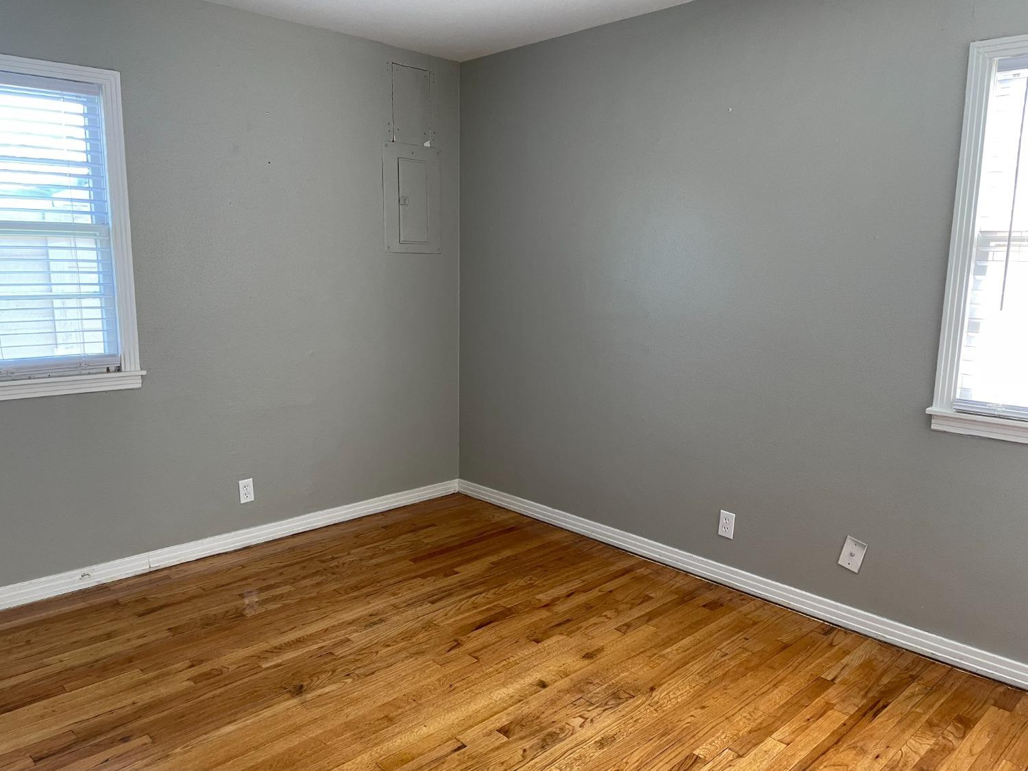 6501 Avenue T Lubbock, TX 79412 - Photo 17 of 20 an empty room with wooden floor and windows