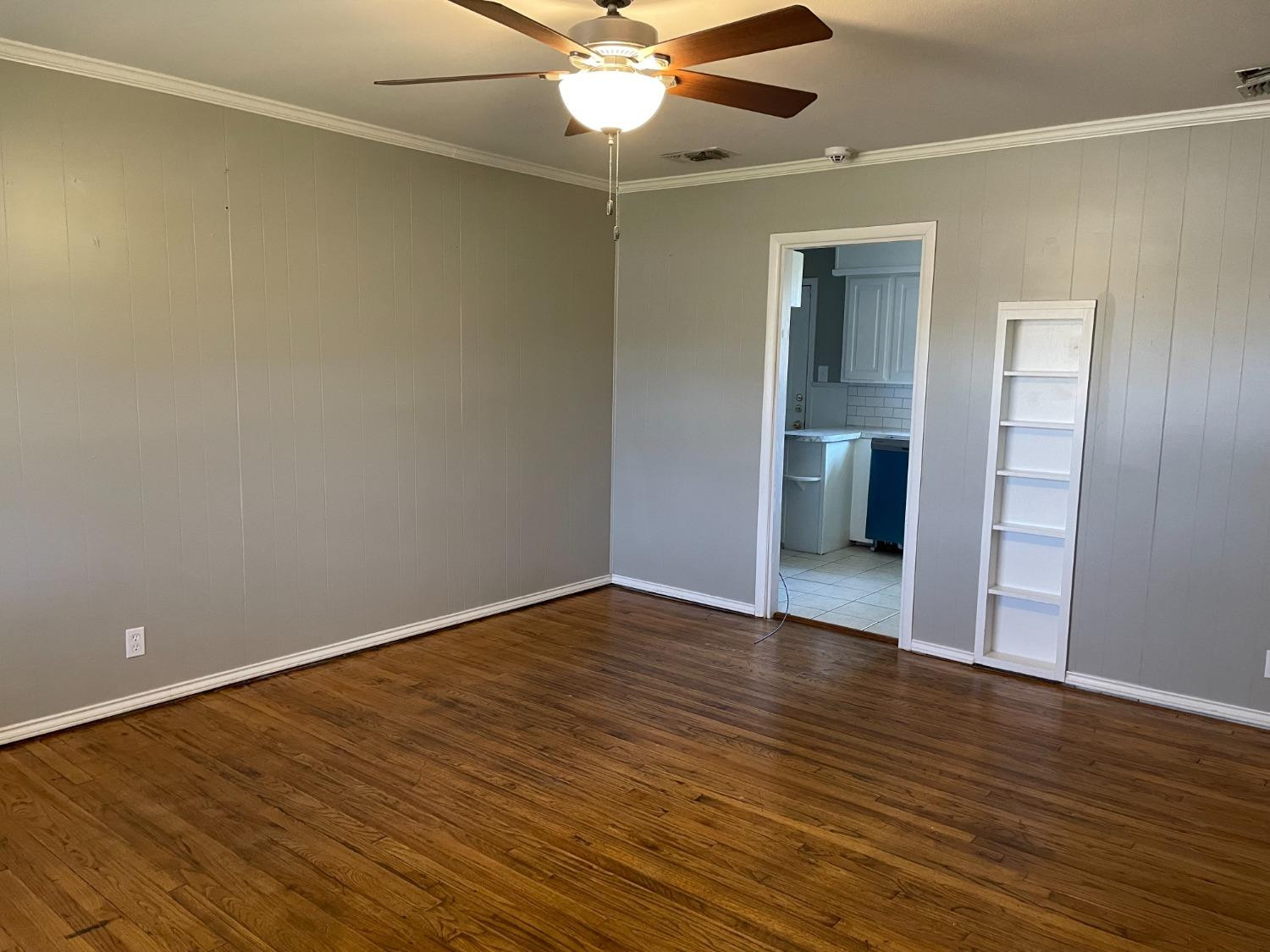 6501 Avenue T Lubbock, TX 79412 - Photo 2 of 20 a view of an empty room with wooden floor and a window