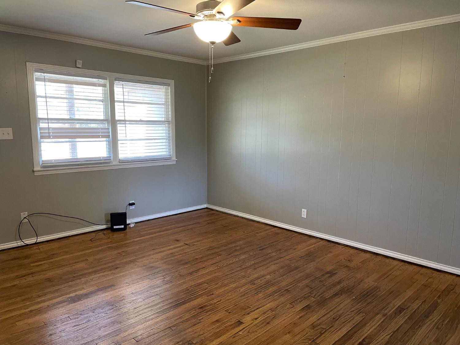6501 Avenue T Lubbock, TX 79412 - Photo 5 of 20 an empty room with wooden floor and windows