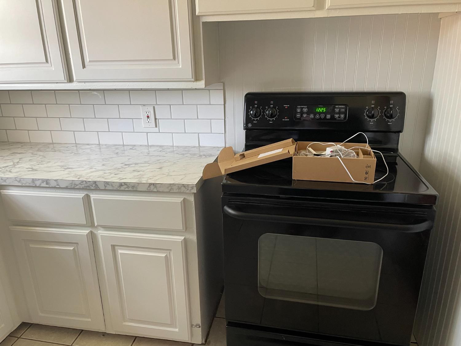 6501 Avenue T Lubbock, TX 79412 - Photo 7 of 20 a stove top oven sitting inside of a kitchen
