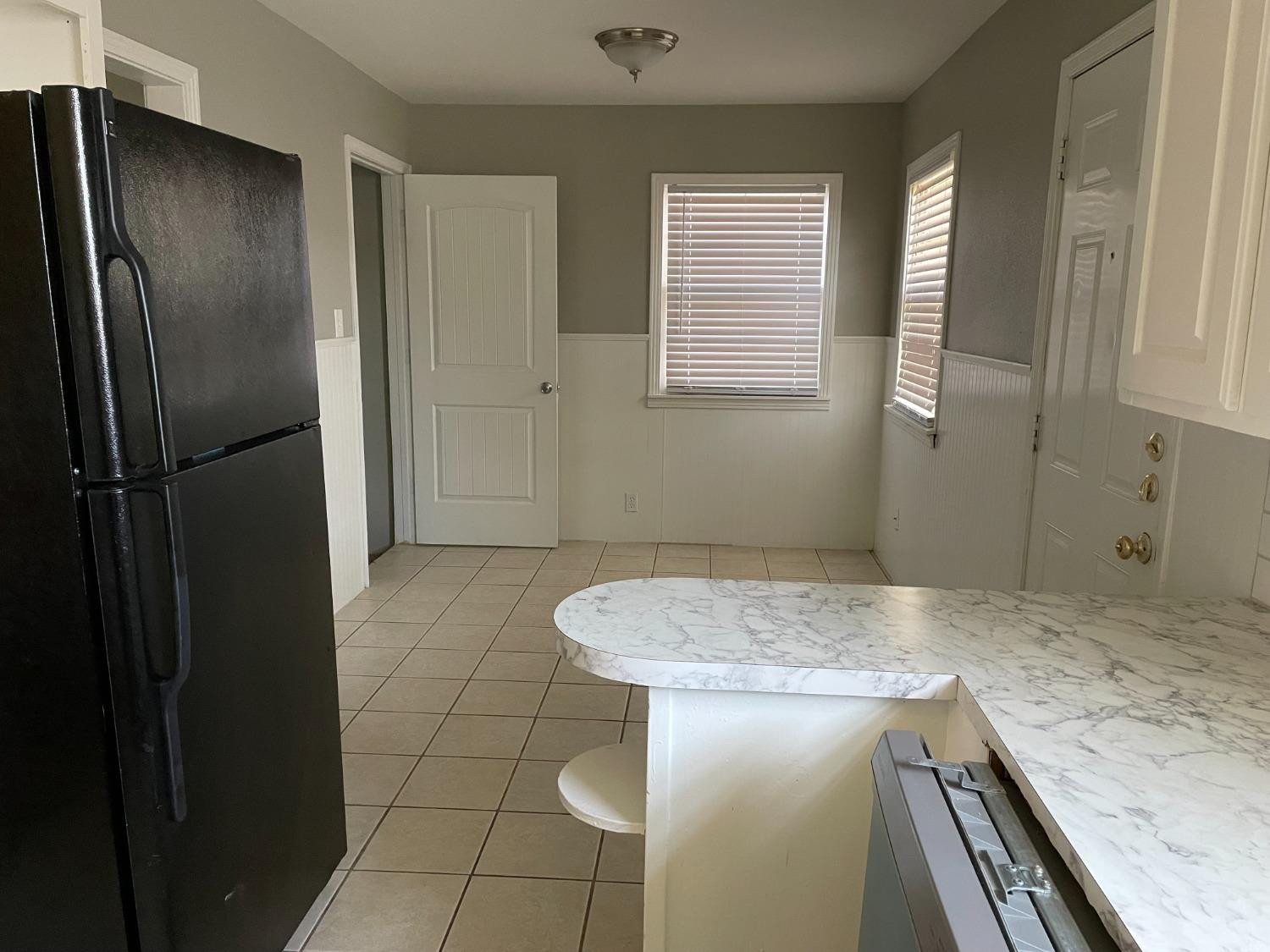 6501 Avenue T Lubbock, TX 79412 - Photo 8 of 20 a bathroom with a granite countertop sink a toilet and shower
