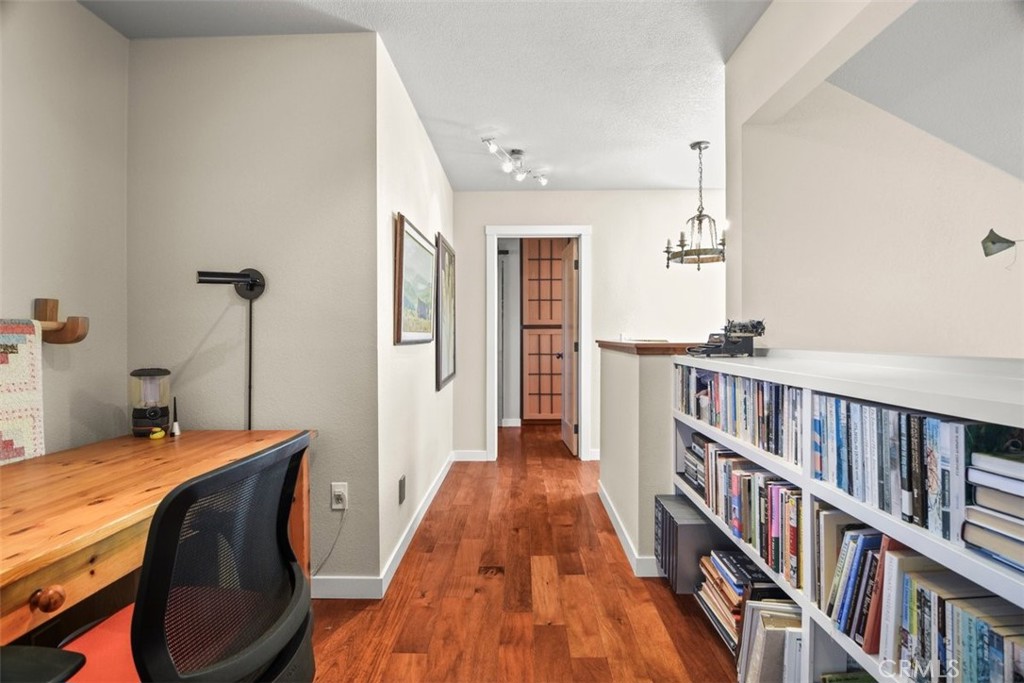 279 Tempus Circle Arroyo Grande, CA 93420 - Photo 12 of 38 a bedroom with a bed and a book shelf