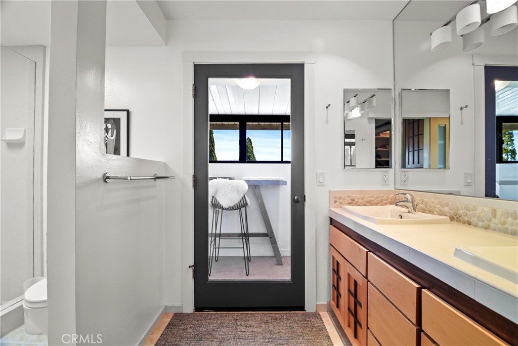 279 Tempus Circle Arroyo Grande, CA 93420 - Photo 17 of 38 a bathroom with a granite countertop sink a toilet and a mirror