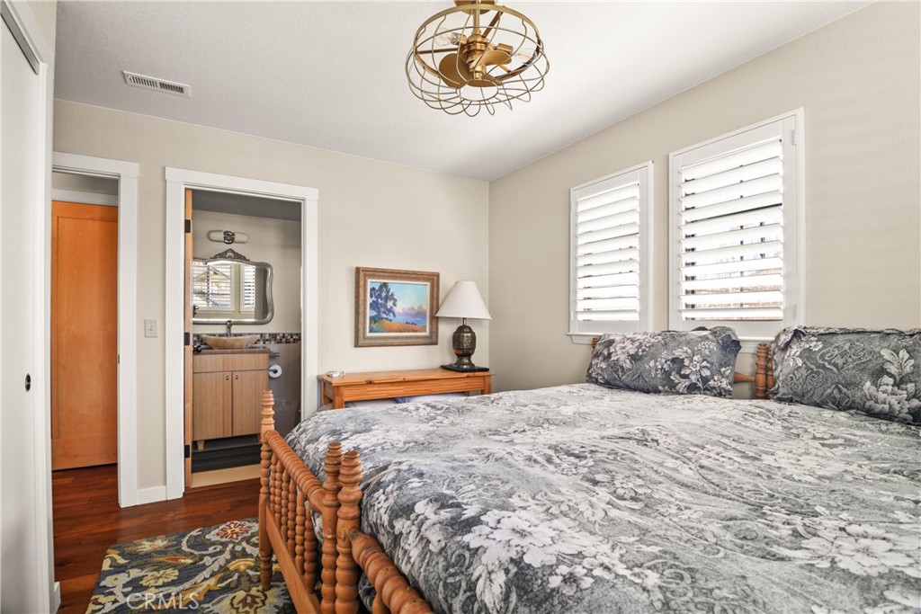 279 Tempus Circle Arroyo Grande, CA 93420 - Photo 21 of 38 a bedroom with a bed and a chandelier