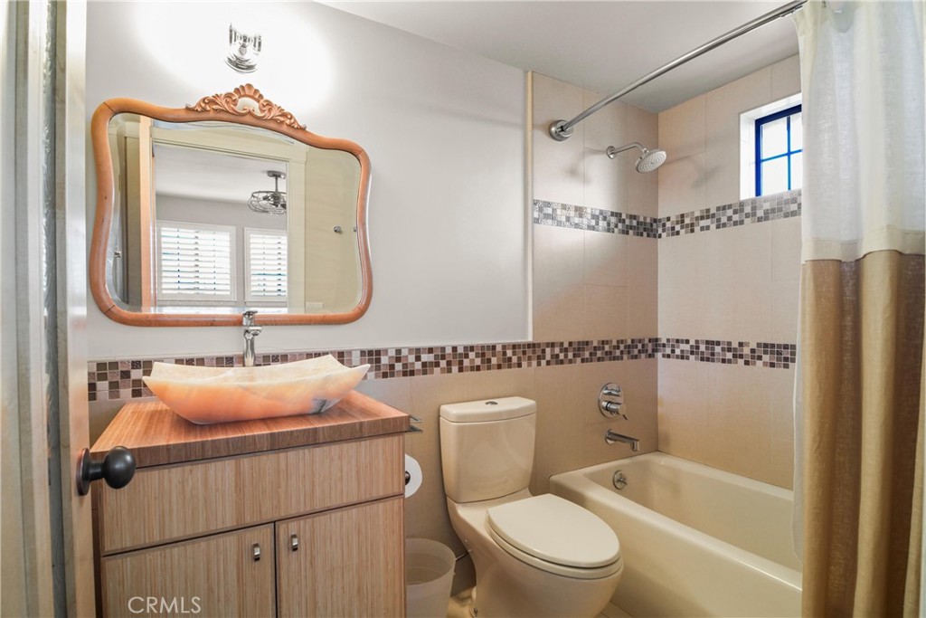 279 Tempus Circle Arroyo Grande, CA 93420 - Photo 22 of 38 a bathroom with a toilet sink vanity tub and shower