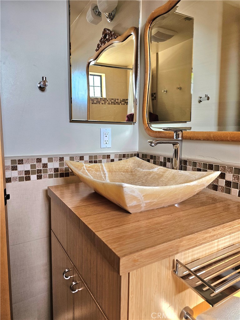 279 Tempus Circle Arroyo Grande, CA 93420 - Photo 23 of 38 a bathroom with a sink and a mirror