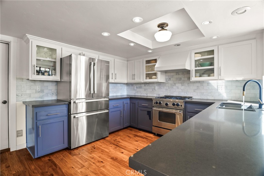 279 Tempus Circle Arroyo Grande, CA 93420 - Photo 8 of 38 a kitchen with kitchen island granite countertop stainless steel appliances and wooden cabinets