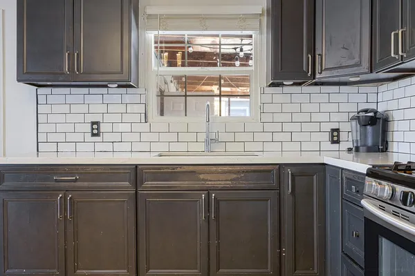 a kitchen with stainless steel appliances wooden cabinets and a sink