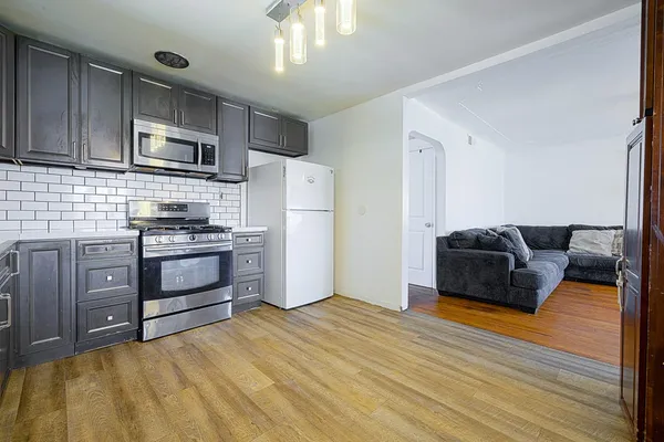 a kitchen with stainless steel appliances a refrigerator a stove a microwave and cabinets