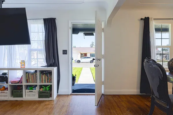 hallway view with wooden floor and windows