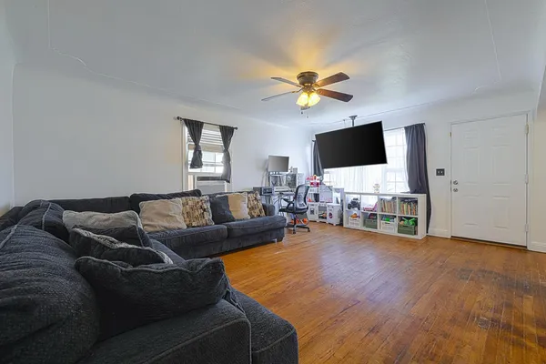 a living room with furniture and a flat screen tv