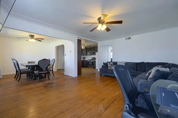 a living room with furniture and a chandelier