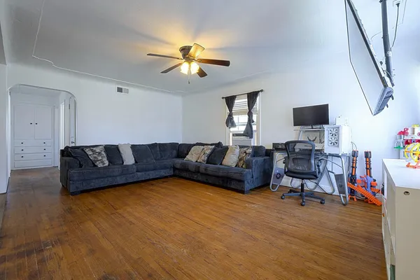 a living room with furniture and a flat screen tv