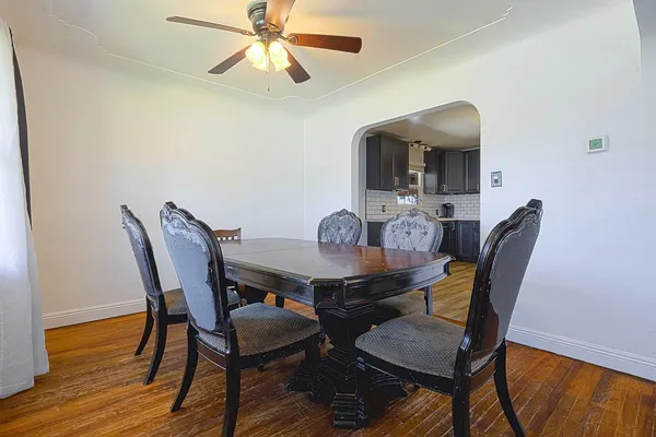 a view of a dining room with furniture and wooden floor
