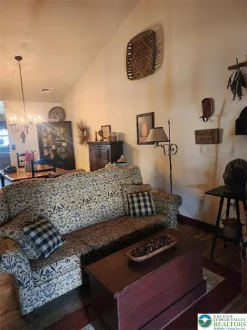 a living room with furniture rug and lamp