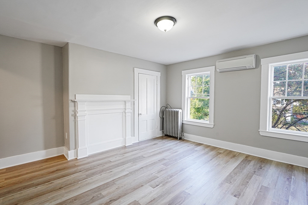 72 Main Street Pepperell, MA 01463 - Photo 6 of 26 an empty room with wooden floor and windows