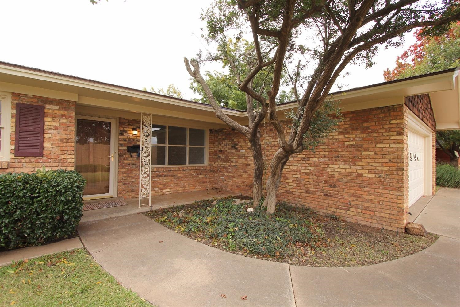4711 27th Street Lubbock, TX 79410 - Photo 2 of 10 front view of a house with a yard