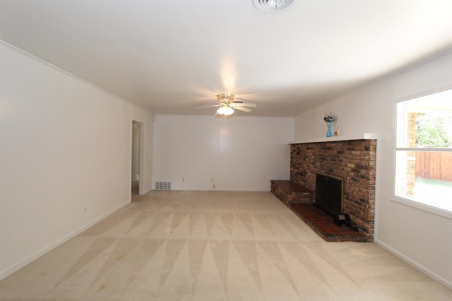 4711 27th Street Lubbock, TX 79410 - Photo 7 of 10 an empty room with windows and fireplace