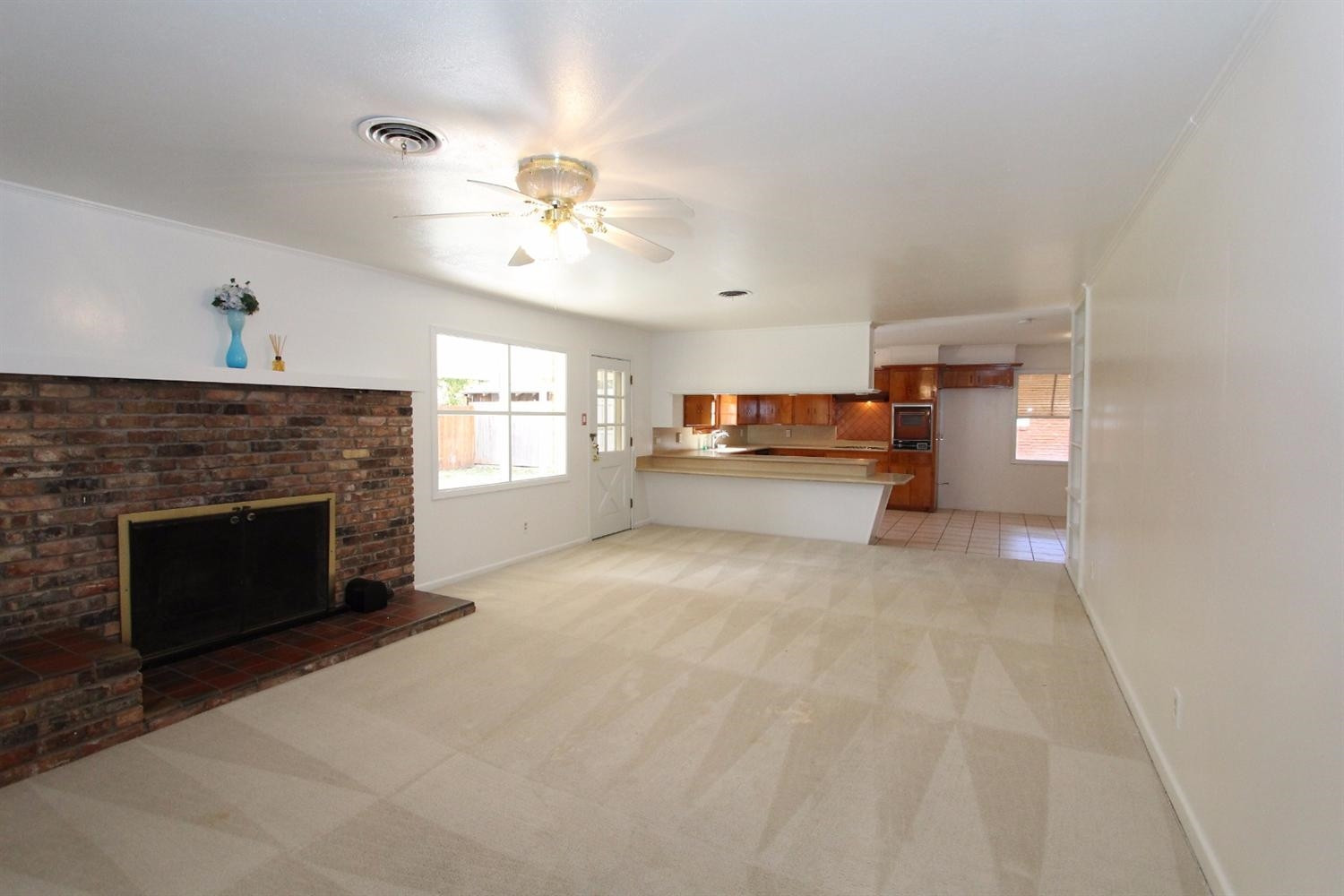 4711 27th Street Lubbock, TX 79410 - Photo 8 of 10 a view of a livingroom with a fireplace and a ceiling fan