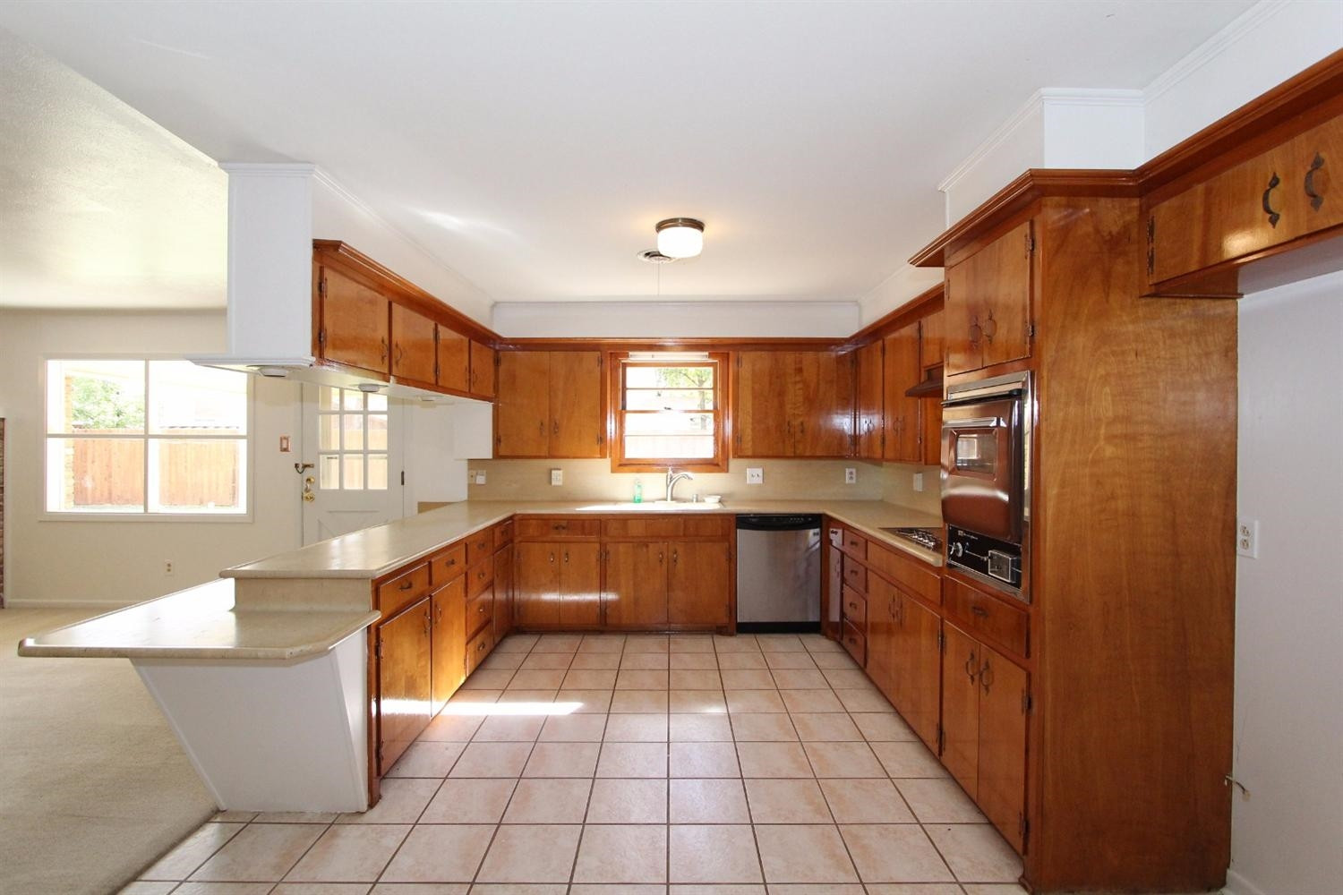 4711 27th Street Lubbock, TX 79410 - Photo 9 of 10 a large kitchen with stainless steel appliances granite countertop a large counter top a stove a sink and a refrigerator