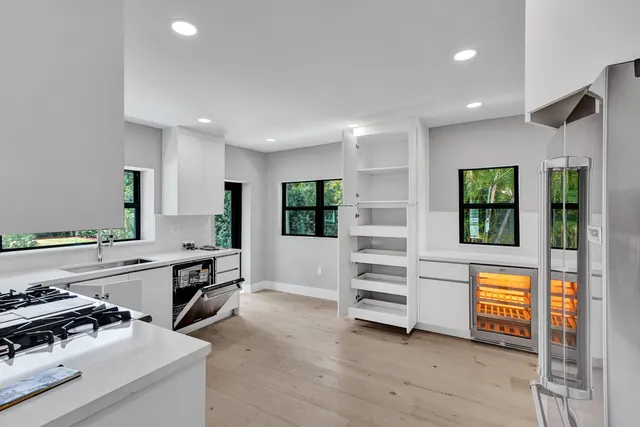 a kitchen with stainless steel appliances a stove a sink and a refrigerator