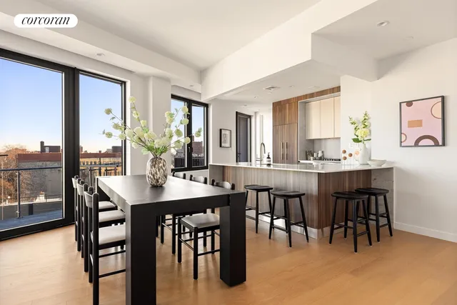 a open dining room with stainless steel appliances granite countertop a table chairs and a refrigerator
