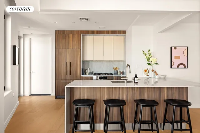 a kitchen with a table chairs sink and cabinets