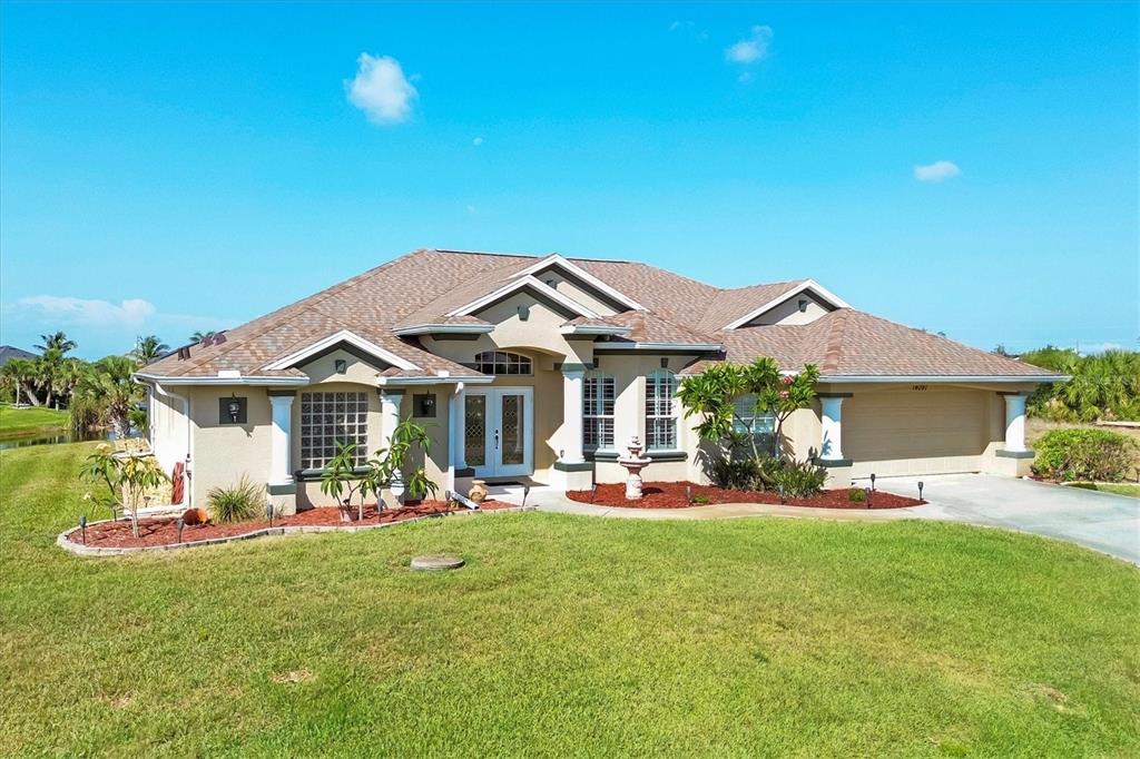 14091 Peekskill Avenue Port Charlotte, FL 33981 - Photo 2 of 53 a front view of a house with a garden