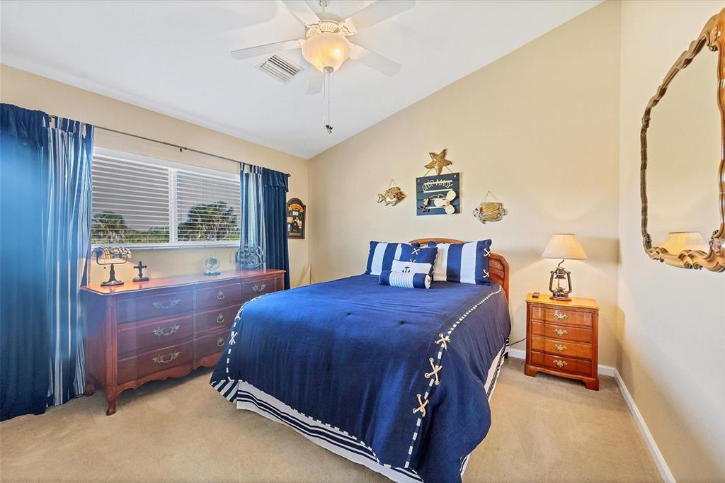 14091 Peekskill Avenue Port Charlotte, FL 33981 - Photo 23 of 53 a bedroom with a bed and a chandelier