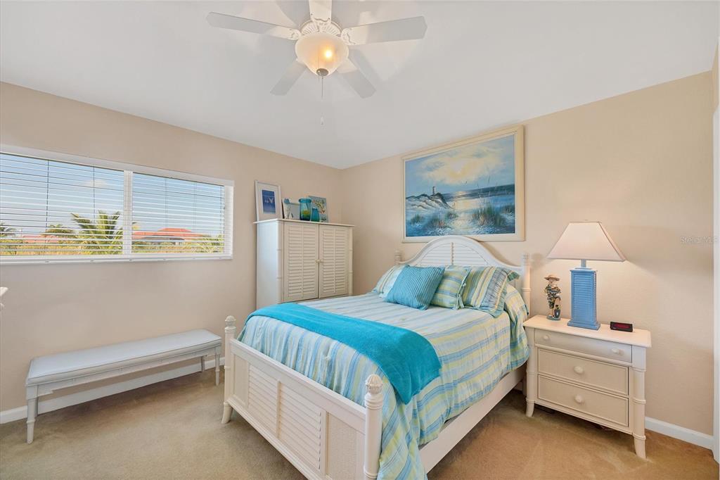 14091 Peekskill Avenue Port Charlotte, FL 33981 - Photo 25 of 53 a bedroom with a bed and a chandelier