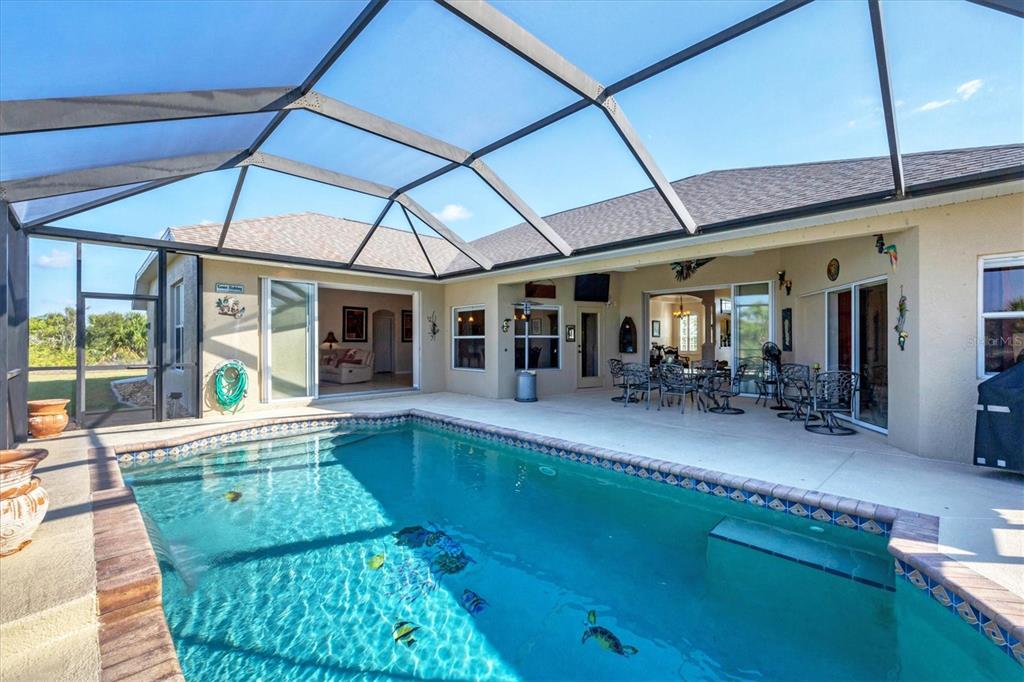 14091 Peekskill Avenue Port Charlotte, FL 33981 - Photo 31 of 53 a view of a swimming pool with outdoor seating