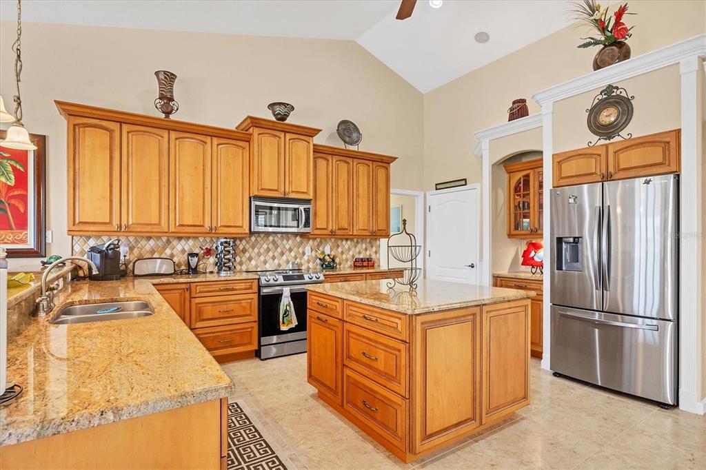 14091 Peekskill Avenue Port Charlotte, FL 33981 - Photo 10 of 53 a kitchen with stainless steel appliances granite countertop a sink and a refrigerator