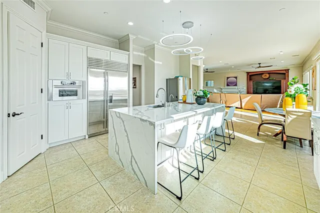 a bathroom with a granite countertop sink a potted plant and a window