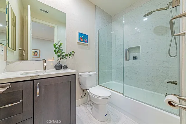a view of a kitchen with stainless steel appliances kitchen island granite countertop a refrigerator and a sink