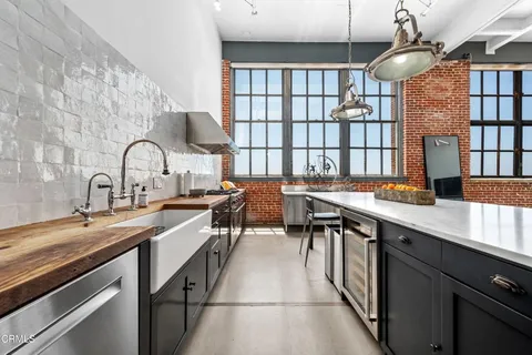 a kitchen with a sink cabinets and appliances