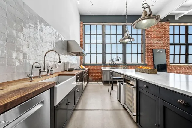 a kitchen with a sink cabinets and appliances