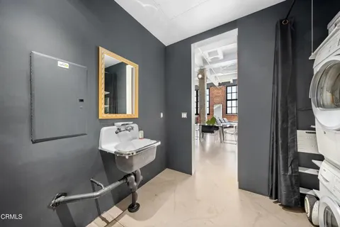 a bathroom with a sink mirror and toilet