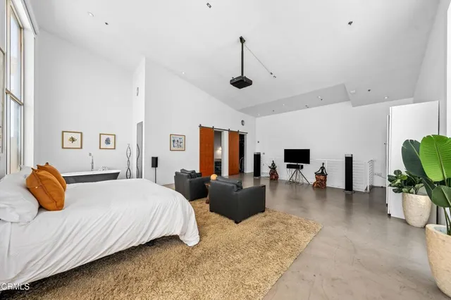 a bedroom with a bed and ceiling fan