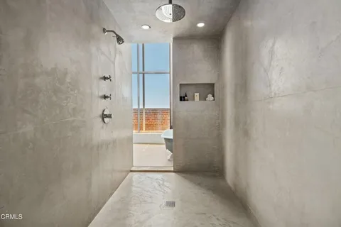 a bathroom with a shower and a glass door