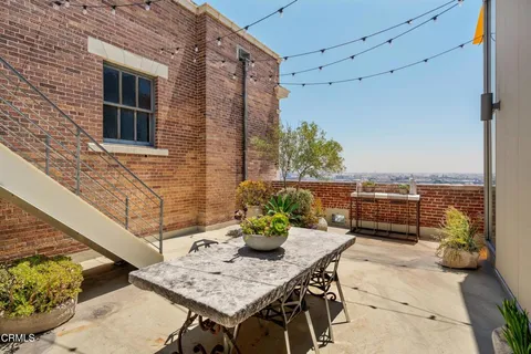 a view of a terrace with furniture and a potted plant